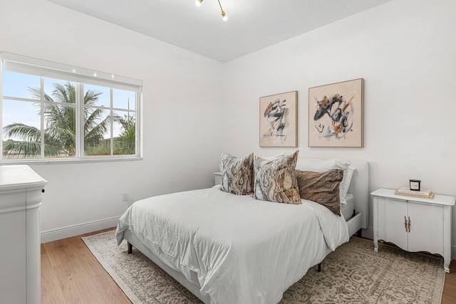 674 NW Library Commons Way, Boca Raton, FL 33432 - bedroom with light wood-type flooring and baseboards