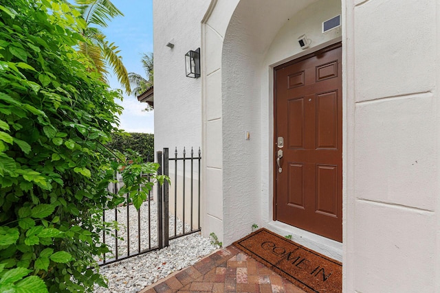 674 NW Library Commons Way, Boca Raton, FL 33432 - doorway to property featuring stucco siding