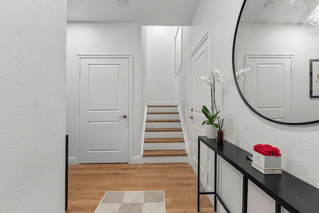 674 NW Library Commons Way, Boca Raton, FL 33432 - corridor with a textured wall, light wood-style flooring, and stairway