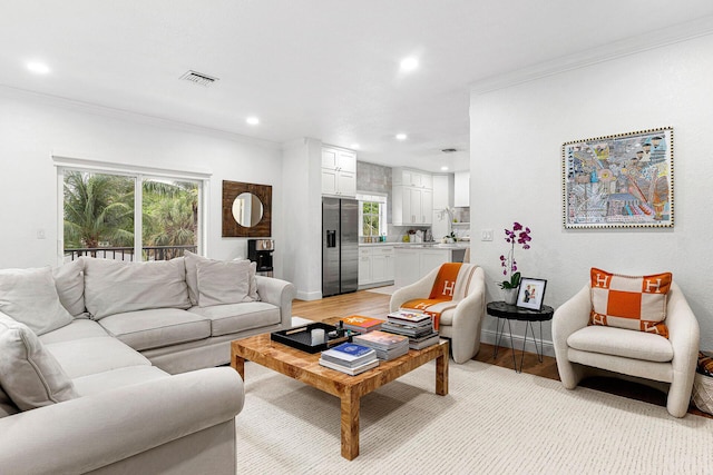 674 NW Library Commons Way, Boca Raton, FL 33432 - living room featuring crown molding, recessed lighting, light wood finished floors, and plenty of natural light