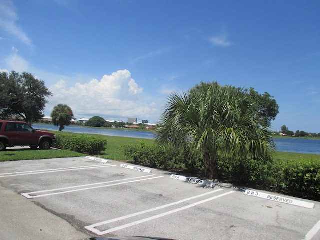 470 Executive Center Dr Unit 2K, West Palm Beach, FL 33401 - uncovered parking lot featuring a water view