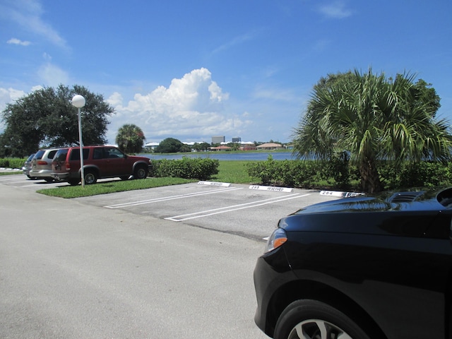 470 Executive Center Dr Unit 2K, West Palm Beach, FL 33401 - uncovered parking lot featuring a water view