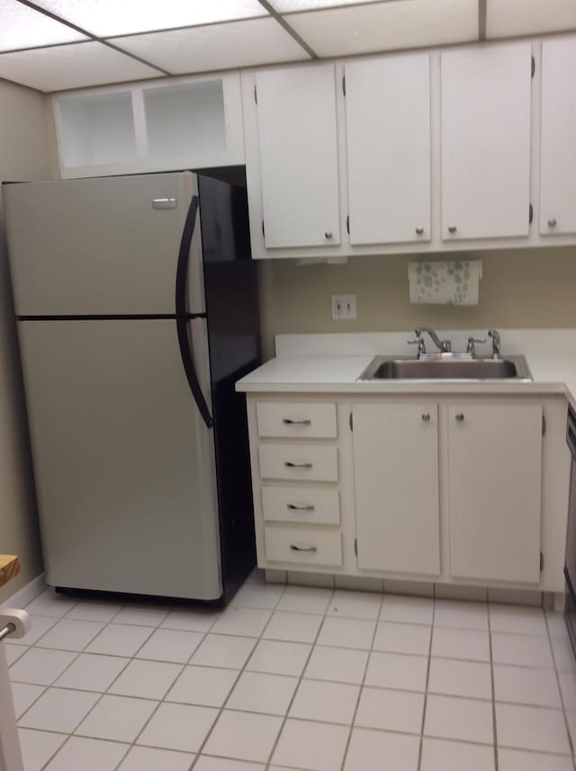 470 Executive Center Dr Unit 2K, West Palm Beach, FL 33401 - kitchen with freestanding refrigerator, light countertops, white cabinetry, and light tile patterned floors