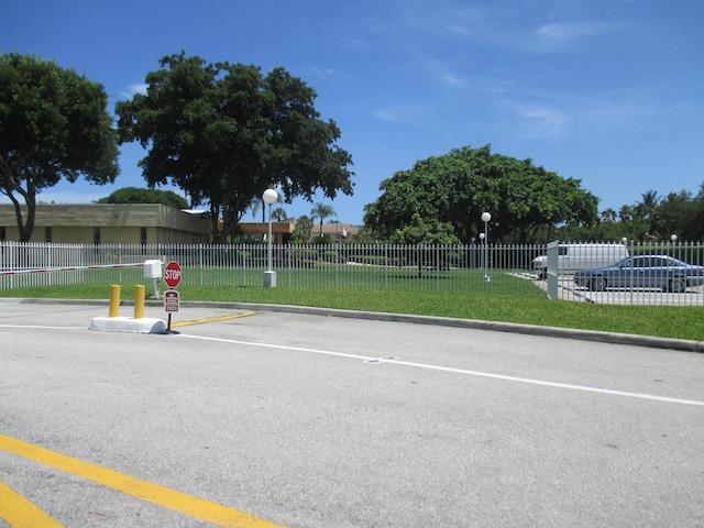 470 Executive Center Dr Unit 2K, West Palm Beach, FL 33401 - view of asphalt road with curbs, street lights, and traffic signs