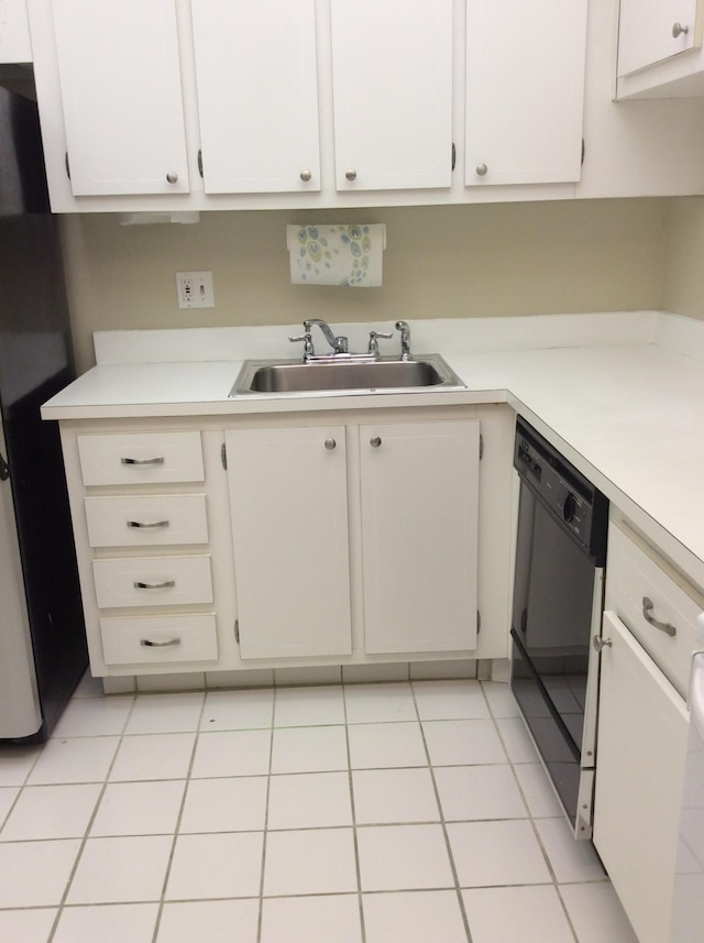470 Executive Center Dr Unit 2K, West Palm Beach, FL 33401 - kitchen featuring black dishwasher, light countertops, and white cabinets