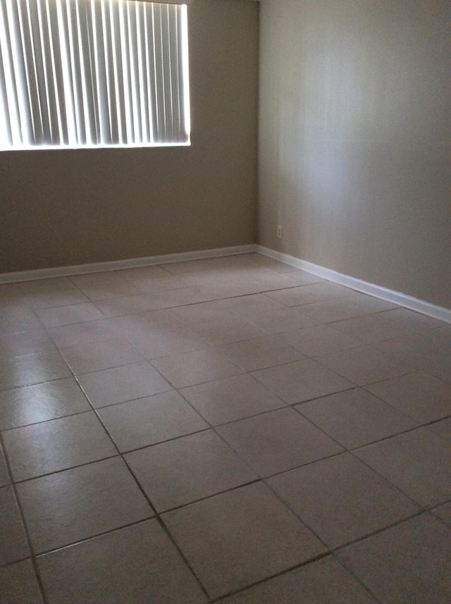 470 Executive Center Dr Unit 2K, West Palm Beach, FL 33401 - tiled empty room featuring baseboards
