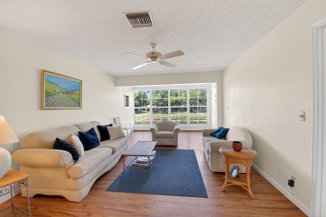 1030 Citrus Way Unit 204, Delray Beach, FL 33445 - living area featuring a textured ceiling, wood finished floors, and ceiling fan