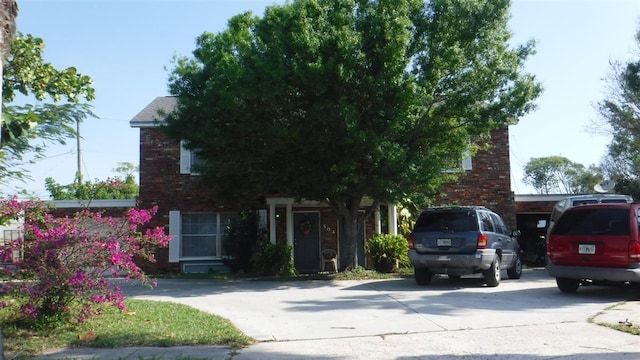 504 Mayflower Ln, Fort Pierce, FL 34950 - obstructed view of property with brick siding and concrete driveway