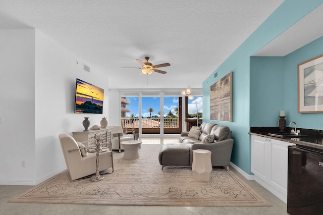 700 Ocean Royale Way Unit 202, Juno Beach, FL 33408 - living area featuring a ceiling fan and a textured ceiling