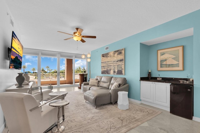 700 Ocean Royale Way Unit 202, Juno Beach, FL 33408 - living area with a ceiling fan and a textured ceiling