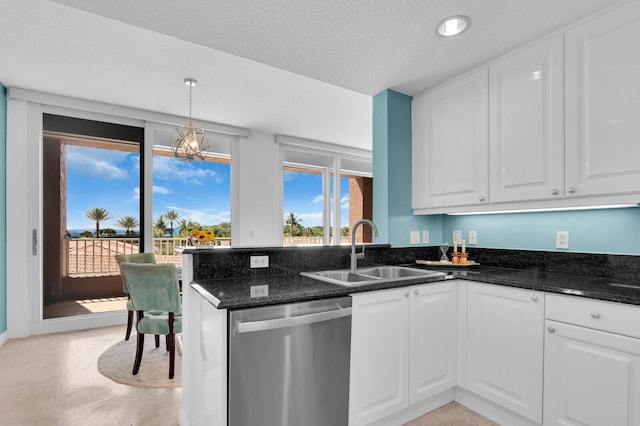 700 Ocean Royale Way Unit 202, Juno Beach, FL 33408 - kitchen with stainless steel dishwasher, white cabinetry, dark stone countertops, a peninsula, and pendant lighting