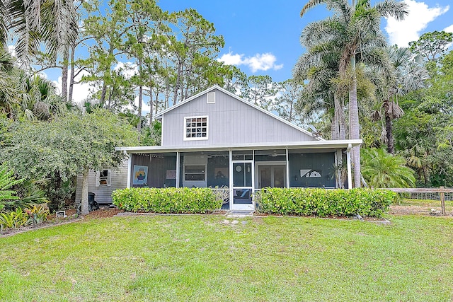15629 95th Ave N, Jupiter, FL 33478 - view of front facade featuring a sunroom and a front lawn