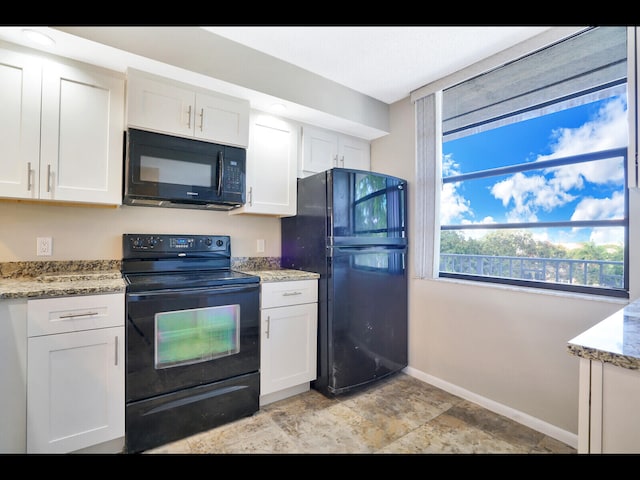 3636 Whitehall Dr Unit 401, West Palm Beach, FL 33401 - kitchen with black appliances, white cabinets, stone finish flooring, and light stone counters