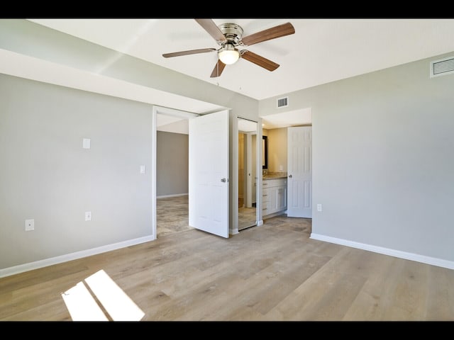3636 Whitehall Dr Unit 401, West Palm Beach, FL 33401 - unfurnished bedroom featuring light wood-style flooring, a ceiling fan, and connected bathroom