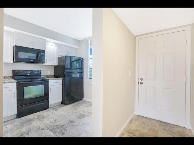 3636 Whitehall Dr Unit 401, West Palm Beach, FL 33401 - kitchen with black appliances, light stone countertops, and white cabinetry