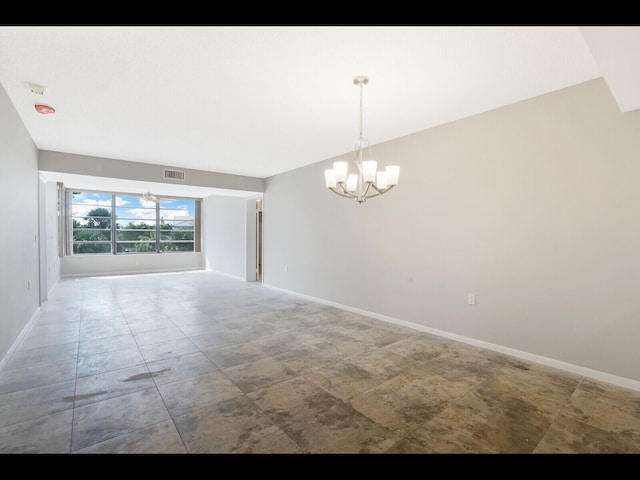 3636 Whitehall Dr Unit 401, West Palm Beach, FL 33401 - empty room featuring a chandelier and baseboards