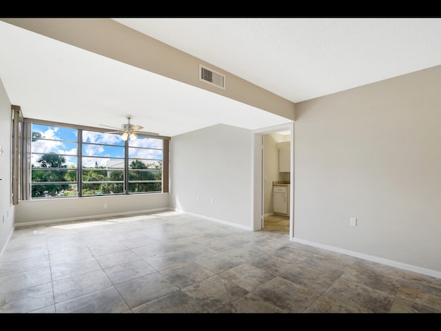 3636 Whitehall Dr Unit 401, West Palm Beach, FL 33401 - spare room featuring baseboards and ceiling fan
