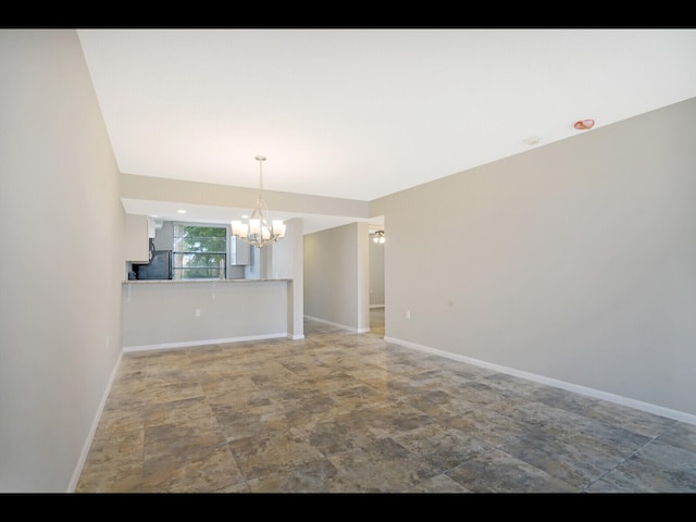 3636 Whitehall Dr Unit 401, West Palm Beach, FL 33401 - spare room featuring a chandelier and stone finish flooring