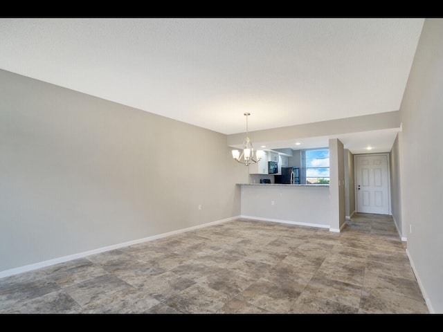 3636 Whitehall Dr Unit 401, West Palm Beach, FL 33401 - unfurnished room featuring a chandelier and baseboards