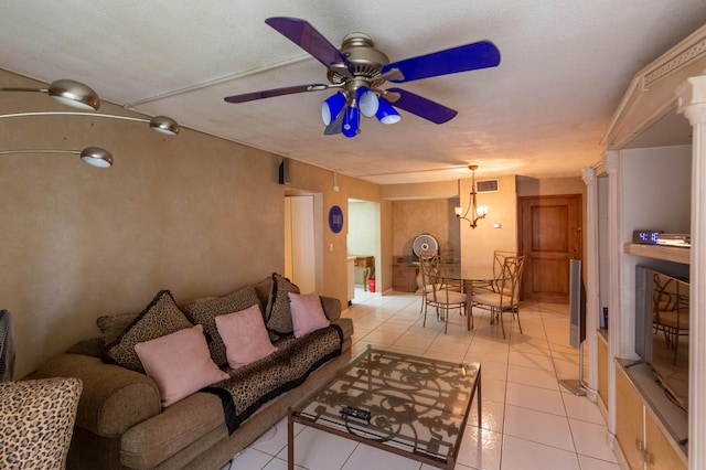 1428 SE 4th Ave Unit 127, Deerfield Beach, FL 33441 - living room featuring a ceiling fan, light tile patterned flooring, decorative columns, and a chandelier