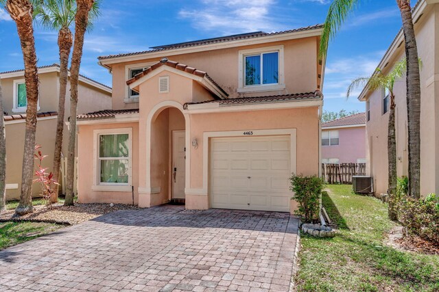 4463 Lake Tahoe Cir, West Palm Beach, FL 33409 - view of front of property featuring a tiled roof, stucco siding, decorative driveway, and a garage