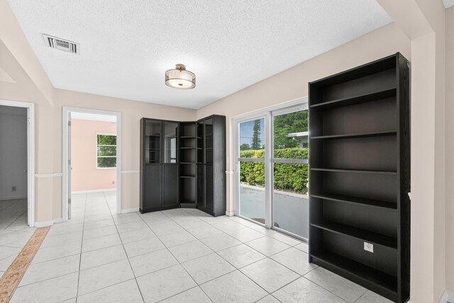 2203 Campanelli Blvd, Boynton Beach, FL 33426 - unfurnished dining area featuring a textured ceiling and light tile patterned flooring
