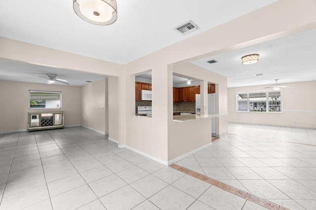 2203 Campanelli Blvd, Boynton Beach, FL 33426 - unfurnished living room with ceiling fan and light tile patterned floors
