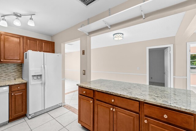 2203 Campanelli Blvd, Boynton Beach, FL 33426 - kitchen featuring white appliances, light tile patterned floors, light stone countertops, and brown cabinetry