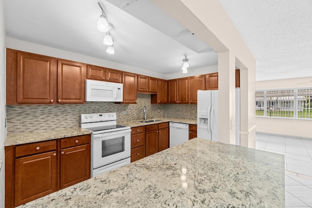 2203 Campanelli Blvd, Boynton Beach, FL 33426 - kitchen featuring white appliances, backsplash, light tile patterned flooring, light stone counters, and brown cabinetry