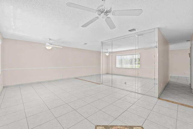 2203 Campanelli Blvd, Boynton Beach, FL 33426 - unfurnished room with a textured ceiling, ceiling fan, and light tile patterned flooring