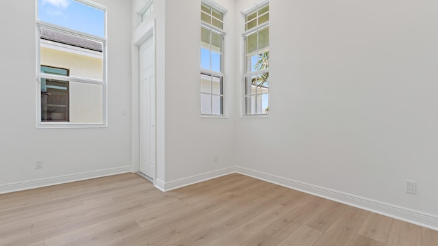 212 SE Via Sangro, Port Saint Lucie, FL 34952 - unfurnished room featuring healthy amount of natural light and light wood finished floors