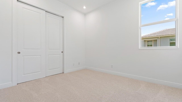 212 SE Via Sangro, Port Saint Lucie, FL 34952 - unfurnished bedroom featuring carpet flooring, a closet, and recessed lighting