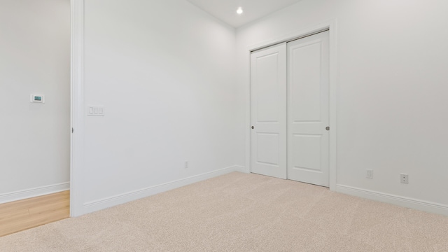 212 SE Via Sangro, Port Saint Lucie, FL 34952 - unfurnished bedroom with light carpet, a closet, and recessed lighting