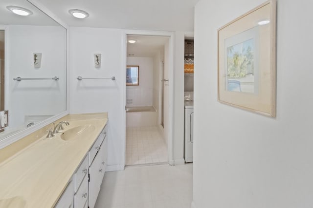 120 Lakeshore Dr Unit 735, North Palm Beach, FL 33408 - full bathroom with vanity, tile patterned floors, and washer / dryer