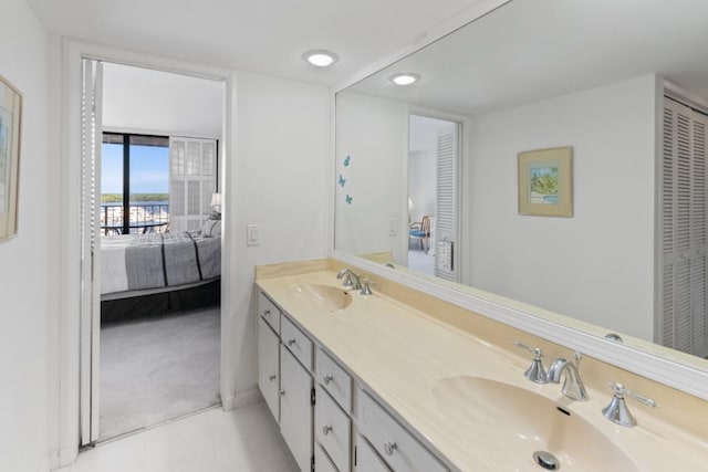 120 Lakeshore Dr Unit 735, North Palm Beach, FL 33408 - bathroom featuring connected bathroom, double vanity, tile patterned floors, and a closet