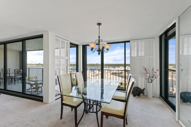 120 Lakeshore Dr Unit 735, North Palm Beach, FL 33408 - dining area featuring floor to ceiling windows, carpet, a chandelier, and healthy amount of natural light