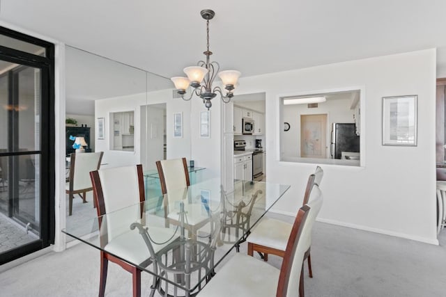 120 Lakeshore Dr Unit 735, North Palm Beach, FL 33408 - dining area featuring light carpet and a chandelier