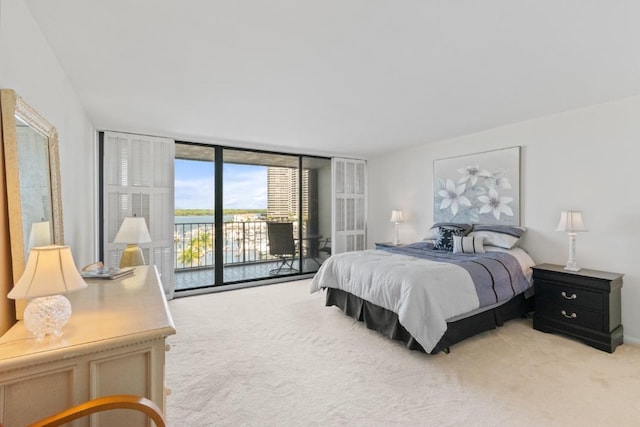 120 Lakeshore Dr Unit 735, North Palm Beach, FL 33408 - bedroom with access to exterior, light carpet, and expansive windows
