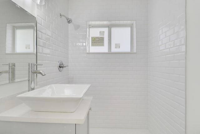 1893 Circle Dr, North Palm Beach, FL 33408 - full bathroom with a tile shower, vanity, and tile walls