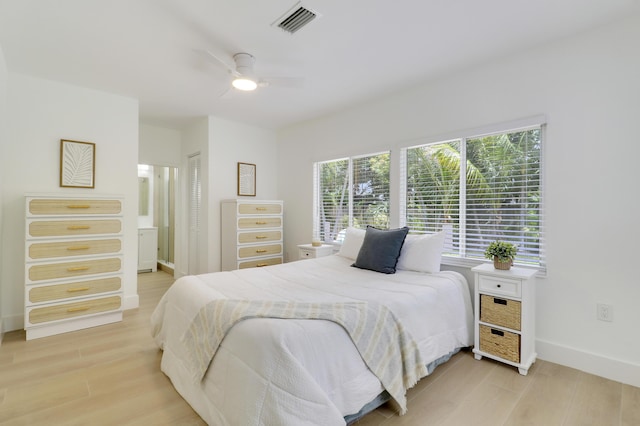 1893 Circle Dr, North Palm Beach, FL 33408 - bedroom featuring light wood-style floors, ensuite bath, and ceiling fan