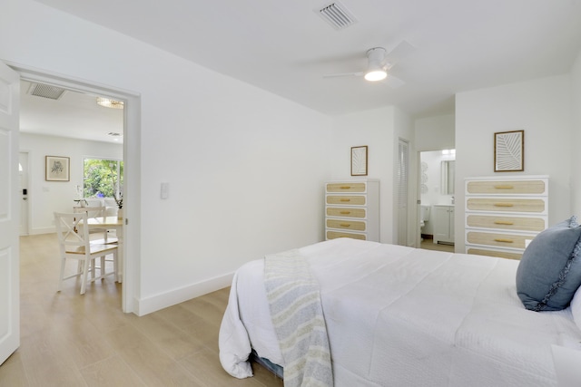 1893 Circle Dr, North Palm Beach, FL 33408 - bedroom with light wood-type flooring, connected bathroom, and ceiling fan
