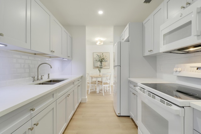 1893 Circle Dr, North Palm Beach, FL 33408 - kitchen featuring white appliances, decorative backsplash, light countertops, light wood-style flooring, and recessed lighting