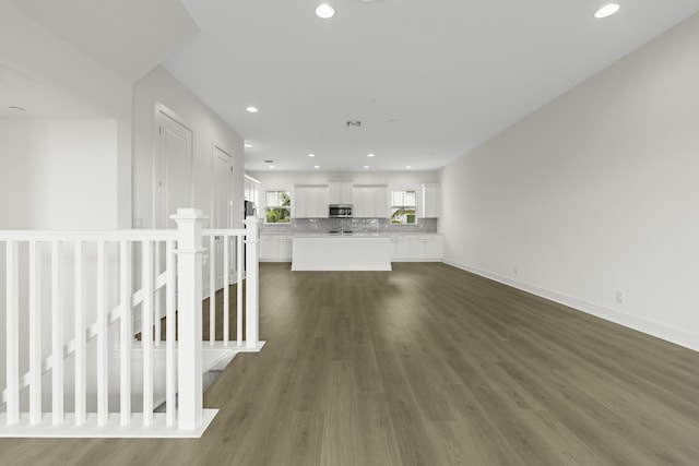 5143 Beckman Ter, Palm Beach Gardens, FL 33418 - unfurnished living room featuring recessed lighting and dark wood-type flooring