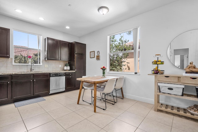 8274 Cascada Isles Dr, Cooper City, FL 33024 - kitchen with dishwasher, dark brown cabinets, decorative backsplash, light tile patterned floors, and light stone countertops