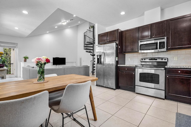 8274 Cascada Isles Dr, Cooper City, FL 33024 - kitchen with stainless steel appliances, tasteful backsplash, dark brown cabinetry, recessed lighting, and light tile patterned floors