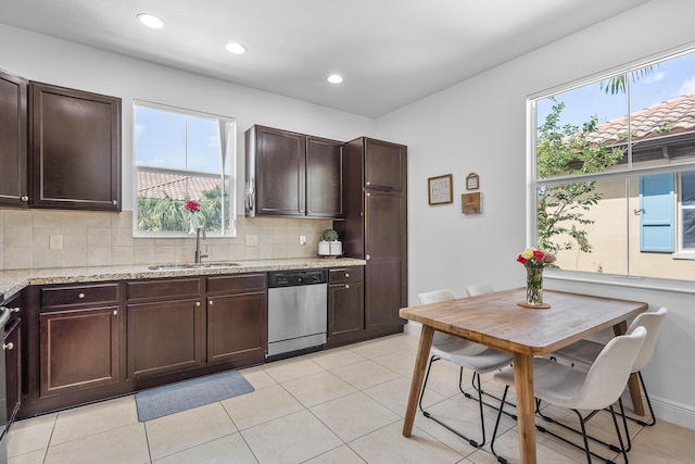 8274 Cascada Isles Dr, Cooper City, FL 33024 - kitchen featuring stainless steel dishwasher, dark brown cabinets, tasteful backsplash, light stone counters, and recessed lighting