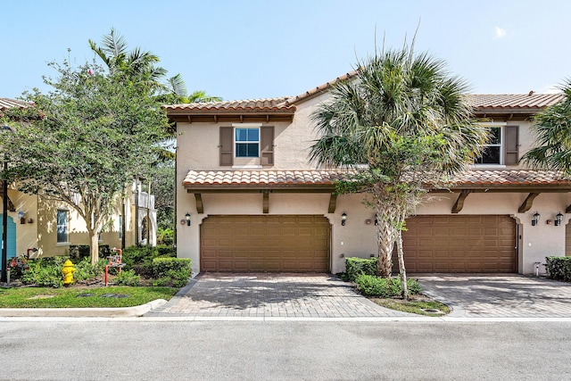 8274 Cascada Isles Dr, Cooper City, FL 33024 - mediterranean / spanish home featuring a garage, a tile roof, decorative driveway, and stucco siding