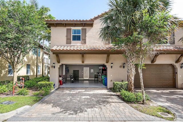8274 Cascada Isles Dr, Cooper City, FL 33024 - mediterranean / spanish-style home with a garage, a tiled roof, decorative driveway, and stucco siding