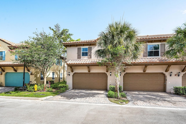 8274 Cascada Isles Dr, Cooper City, FL 33024 - view of front of property featuring an attached garage, decorative driveway, and stucco siding