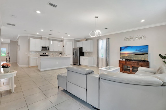 521 SE Plumeria Dr, Port Saint Lucie, FL 34984 - living room featuring ornamental molding, light tile patterned flooring, and recessed lighting
